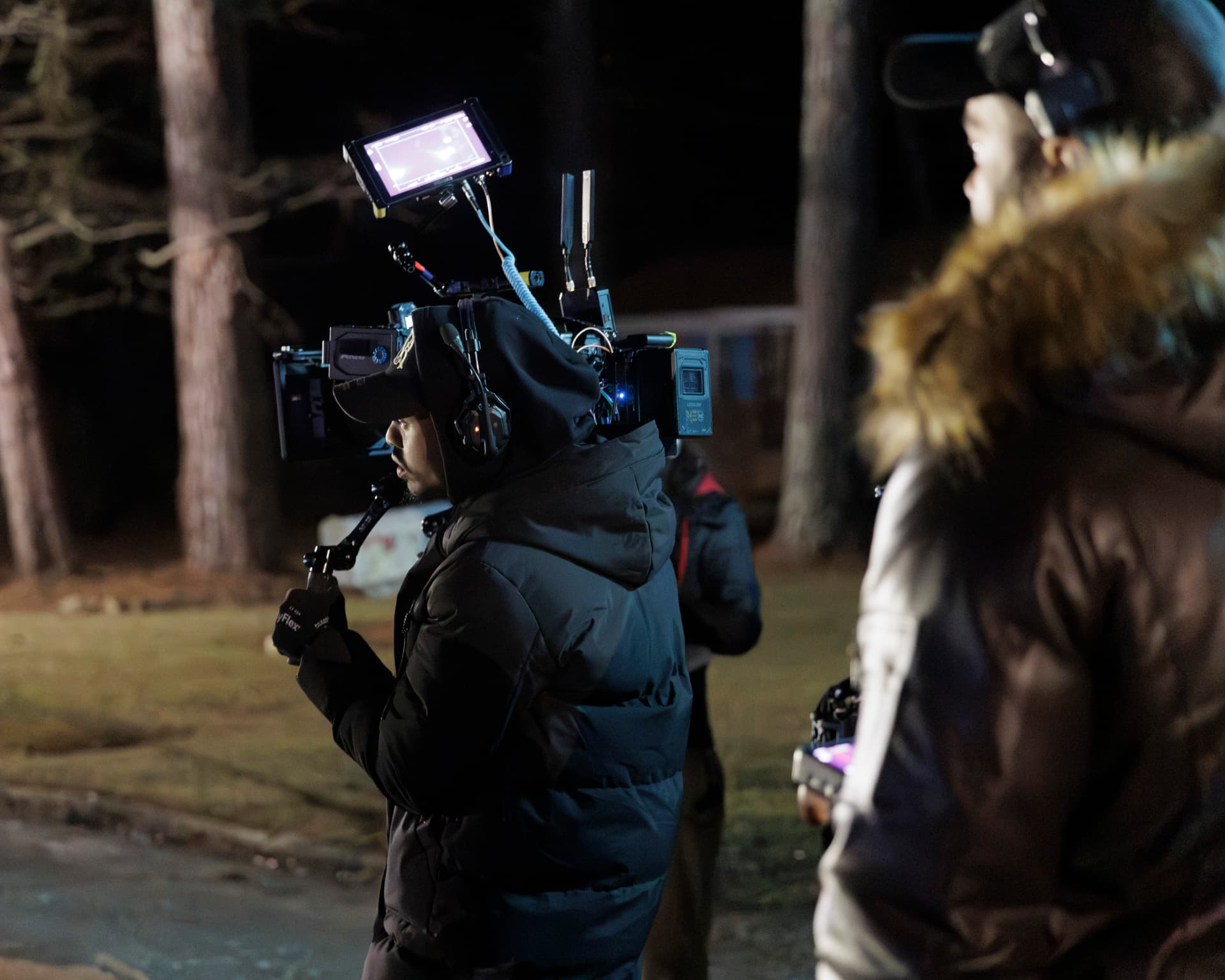 Camera operator working a night exterior